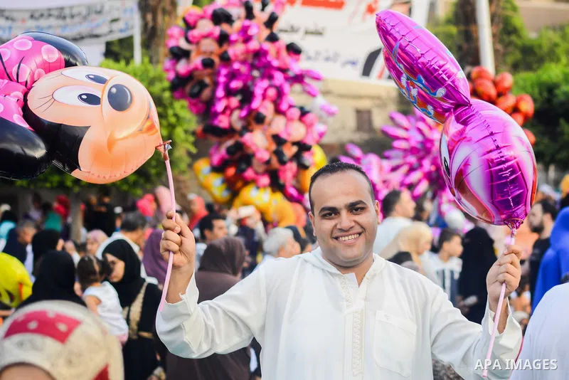 Muslim Egyptians celebrate following the morning prayer of the Eid al-Adha holiday in the capital Cairo on September 12, 2016. Muslims across the world celebrate the annual festival of Eid al-Adha, or the festival of sac...