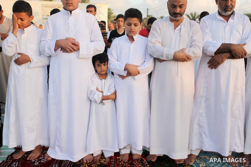 Palestinians attend the morning prayer of the Muslim holiday of the Eid al-Adha on September 12, 2016, in Khan Younis in the southern Gaza strip. Muslims across the world celebrate the annual festival of Eid al-Adha, or...