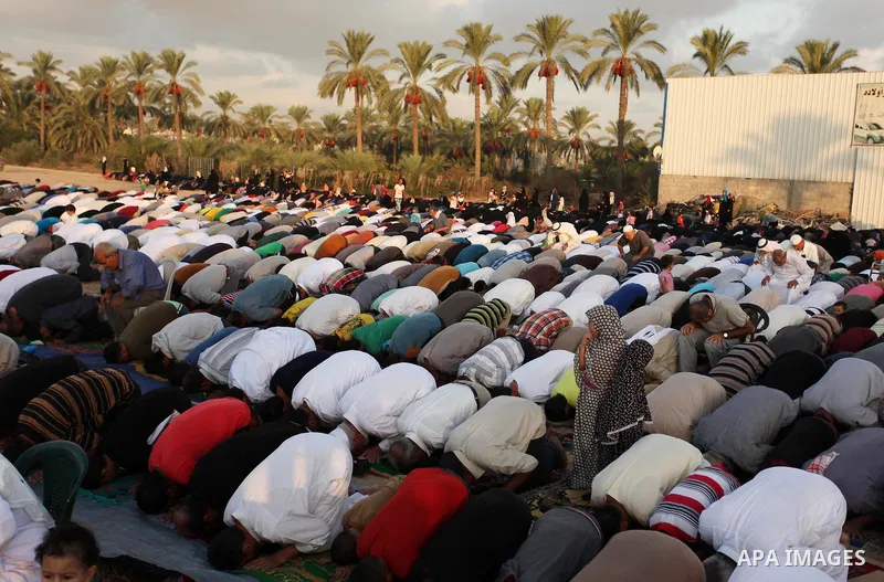 Palestinians attend the morning prayer of the Muslim holiday of the Eid al-Adha on September 12, 2016, in Khan Younis in the southern Gaza strip. Muslims across the world celebrate the annual festival of Eid al-Adha, or...