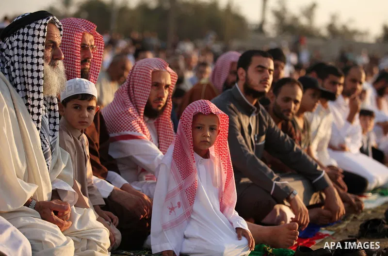 Palestinians attend the morning prayer of the Muslim holiday of the Eid al-Adha on September 12, 2016, in Khan Younis in the southern Gaza strip. Muslims across the world celebrate the annual festival of Eid al-Adha, or...