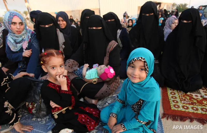 A Palestinian girl attends the morning prayer of the Muslim holiday of the Eid al-Adha on September 12, 2016, in Khan Younis in the southern Gaza strip. Muslims across the world celebrate the annual festival of Eid al-Ad...