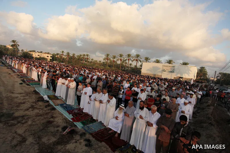 Palestinians attend the morning prayer of the Muslim holiday of the Eid al-Adha on September 12, 2016, in Khan Younis in the southern Gaza strip. Muslims across the world celebrate the annual festival of Eid al-Adha, or...