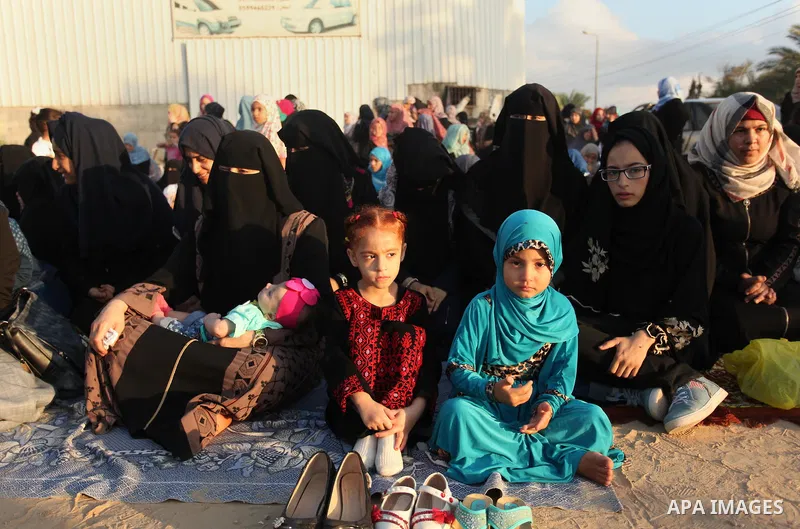 Palestinian girls attend the morning prayer of the Muslim holiday of the Eid al-Adha on September 12, 2016, in Khan Younis in the southern Gaza strip. Muslims across the world celebrate the annual festival of Eid al-Adha...