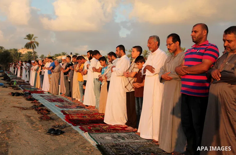 Palestinians attend the morning prayer of the Muslim holiday of the Eid al-Adha on September 12, 2016, in Khan Younis in the southern Gaza strip. Muslims across the world celebrate the annual festival of Eid al-Adha, or...