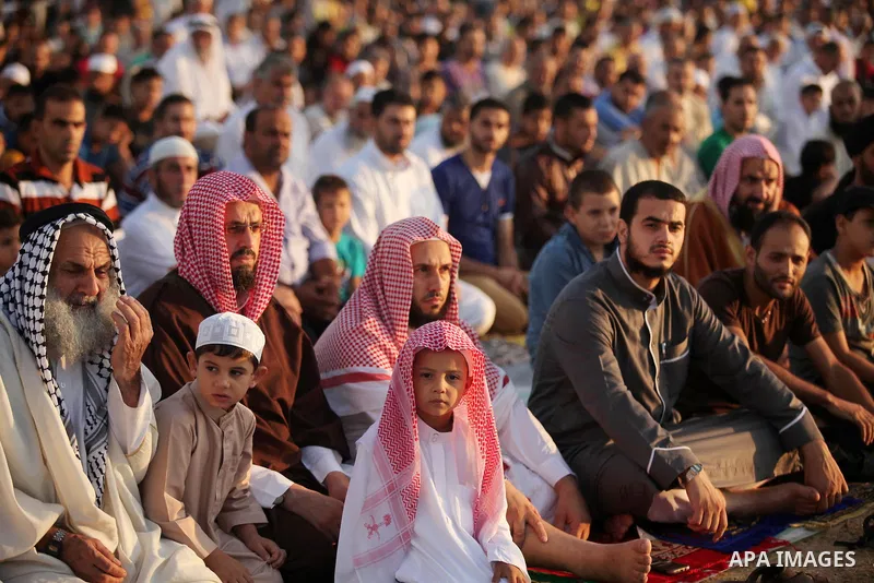Palestinians attend the morning prayer of the Muslim holiday of the Eid al-Adha on September 12, 2016, in Khan Younis in the southern Gaza strip. Muslims across the world celebrate the annual festival of Eid al-Adha, or...