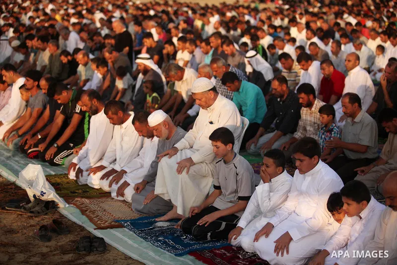 Palestinians attend the morning prayer of the Muslim holiday of the Eid al-Adha on September 12, 2016, in Khan Younis in the southern Gaza strip. Muslims across the world celebrate the annual festival of Eid al-Adha, or...