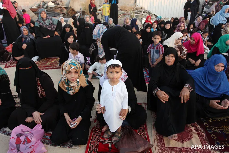 Palestinians attend the morning prayer of the Muslim holiday of the Eid al-Adha on September 12, 2016, in Khan Younis in the southern Gaza strip. Muslims across the world celebrate the annual festival of Eid al-Adha, or...