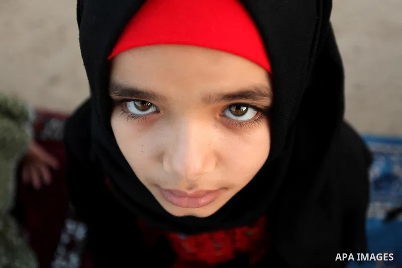 A Palestinian girl attends the morning prayer of the Muslim holiday of the Eid al-Adha on September 12, 2016, in Khan Younis in the southern Gaza strip. Muslims across the world celebrate the annual festival of Eid al-Ad...