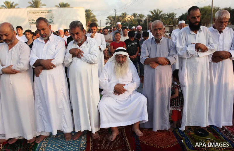 Palestinians attend the morning prayer of the Muslim holiday of the Eid al-Adha on September 12, 2016, in Khan Younis in the southern Gaza strip. Muslims across the world celebrate the annual festival of Eid al-Adha, or...