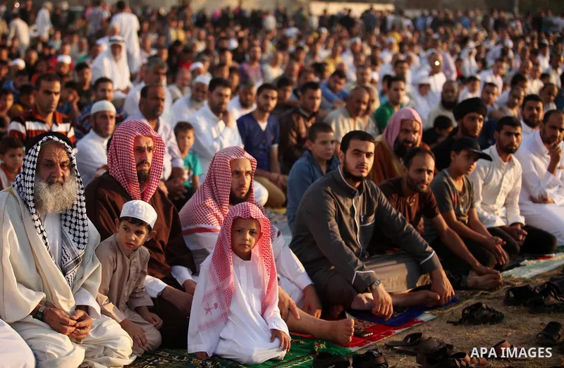 Palestinians attend the morning prayer of the Muslim holiday of the Eid al-Adha on September 12, 2016, in Khan Younis in the southern Gaza strip. Muslims across the world celebrate the annual festival of Eid al-Adha, or...