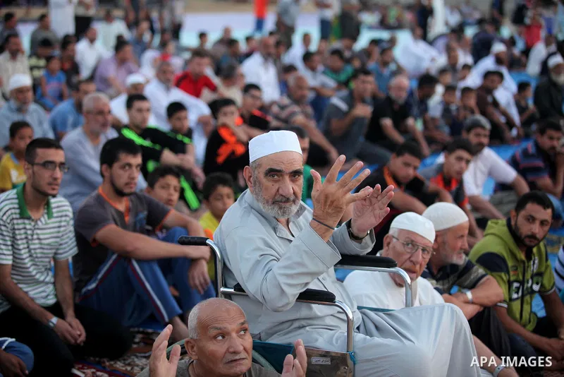 Palestinians attend the morning prayer of the Muslim holiday of the Eid al-Adha on September 12, 2016, in Khan Younis in the southern Gaza strip. Muslims across the world celebrate the annual festival of Eid al-Adha, or...