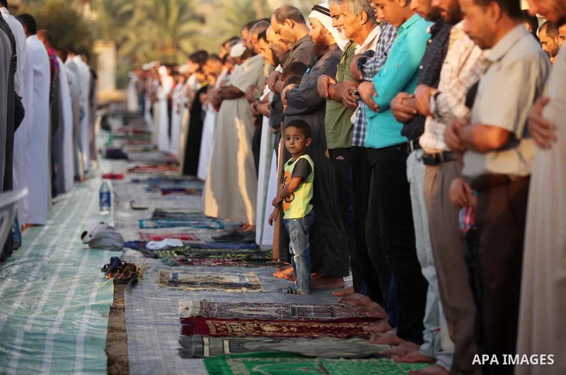 Palestinians attend the morning prayer of the Muslim holiday of the Eid al-Adha on September 12, 2016, in Khan Younis in the southern Gaza strip. Muslims across the world celebrate the annual festival of Eid al-Adha, or...