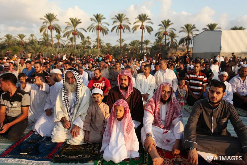 Palestinians attend the morning prayer of the Muslim holiday of the Eid al-Adha on September 12, 2016, in Khan Younis in the southern Gaza strip. Muslims across the world celebrate the annual festival of Eid al-Adha, or...