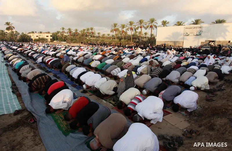 Palestinians attend the morning prayer of the Muslim holiday of the Eid al-Adha on September 12, 2016, in Khan Younis in the southern Gaza strip. Muslims across the world celebrate the annual festival of Eid al-Adha, or...