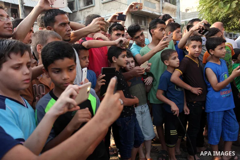 Palestinian Muslims watch the sacrificial animals on the first day of of Eid al-Adha or the feast of sacrifice, in Khan Younis in the southern Gaza Strip on September 12, 2016. Muslims across the world are celebrating th...