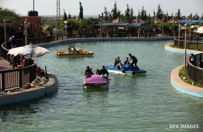 Palestinians enjoy at an amusement park on the third day of Eid al-Adha or the feast of sacrifice in Gaza city, on Sep. 14, 2016. Muslims across the world are celebrating the annual festival of Eid al-Adha, or the Festiv...