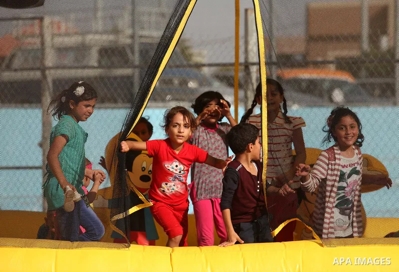 Palestinian children play at an amusement park on the third day of Eid al-Adha or the feast of sacrifice in Gaza city, on Sep. 14, 2016. Muslims across the world are celebrating the annual festival of Eid al-Adha, or the...