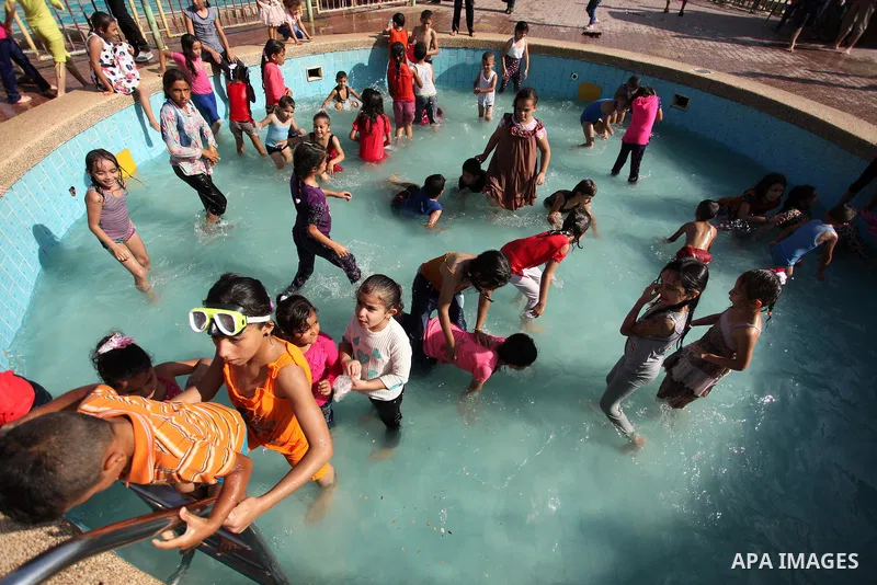 Palestinian children swim at an amusement park on the third day of Eid al-Adha or the feast of sacrifice in Gaza city, on Sep. 14, 2016. Muslims across the world are celebrating the annual festival of Eid al-Adha, or the...
