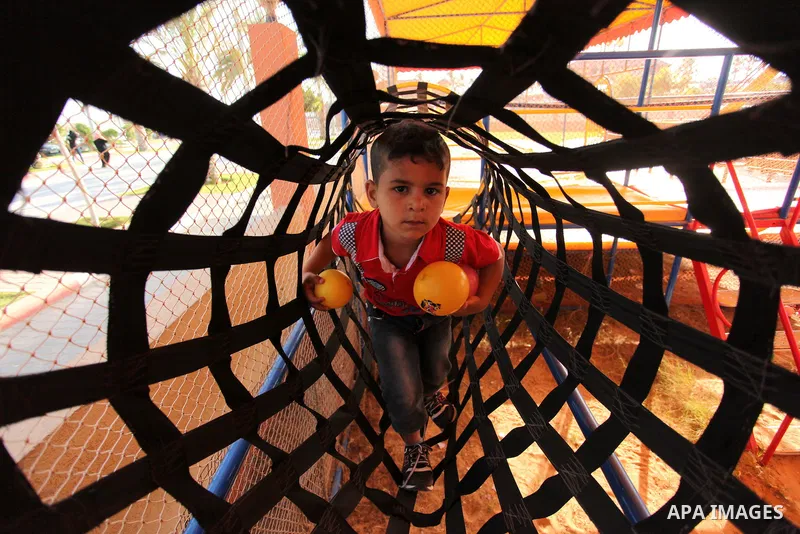 Palestinian children play at an amusement park on the third day of Eid al-Adha or the feast of sacrifice in Gaza city, on Sep. 14, 2016. Muslims across the world are celebrating the annual festival of Eid al-Adha, or the...