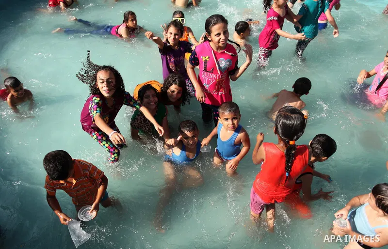 Palestinian children swim at an amusement park on the third day of Eid al-Adha or the feast of sacrifice in Gaza city, on Sep. 14, 2016. Muslims across the world are celebrating the annual festival of Eid al-Adha, or the...