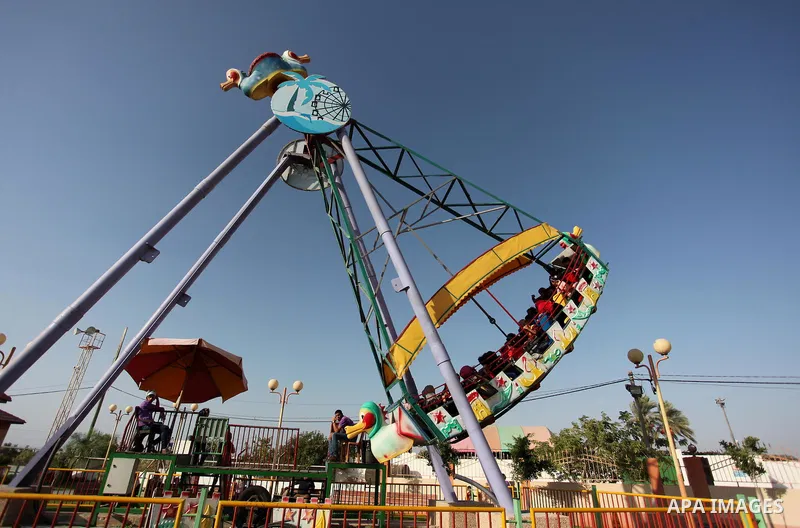 Palestinians take a ride at an amusement park on the third day of Eid al-Adha or the feast of sacrifice in Gaza city, on Sep. 14, 2016. Muslims across the world are celebrating the annual festival of Eid al-Adha, or the...