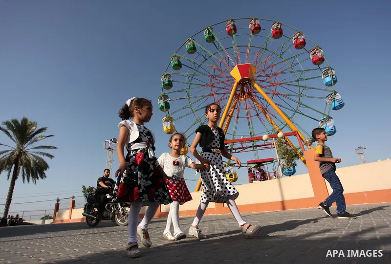 Palestinians take a ride at an amusement park on the third day of Eid al-Adha or the feast of sacrifice in Gaza city, on Sep. 14, 2016. Muslims across the world are celebrating the annual festival of Eid al-Adha, or the...
