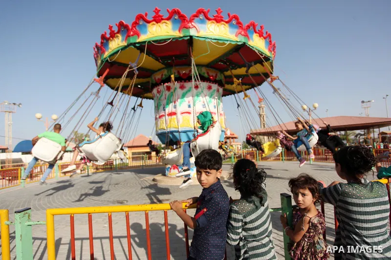 Palestinians take a ride at an amusement park on the third day of Eid al-Adha or the feast of sacrifice in Gaza city, on Sep. 14, 2016. Muslims across the world are celebrating the annual festival of Eid al-Adha, or the...