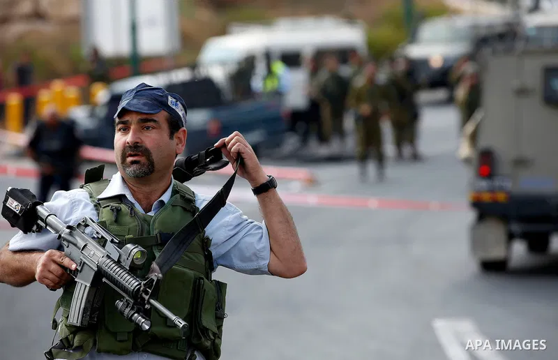 Israeli security forces gather at the scene of what the Israeli military said was a car ramming attack by a Palestinian near the Jewish settlement of Kiryat Arba near the West Bank city of Hebron September 16, 2016. Phot...