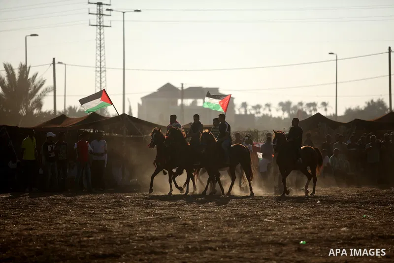 Palestinians ride horses during a Bedouin festival in Dair Al Balah in the central Gaza Strip September 16, 2016. Photo by Ashraf Amra