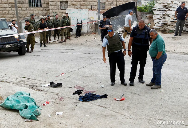 Israeli security forces gather at the scene of a stabbing attack, where a Palestinian stabbed an Israeli soldier before he was shot dead, in the flashpoint West Bank city of Hebron on September 17, 2016. An Israeli milit...
