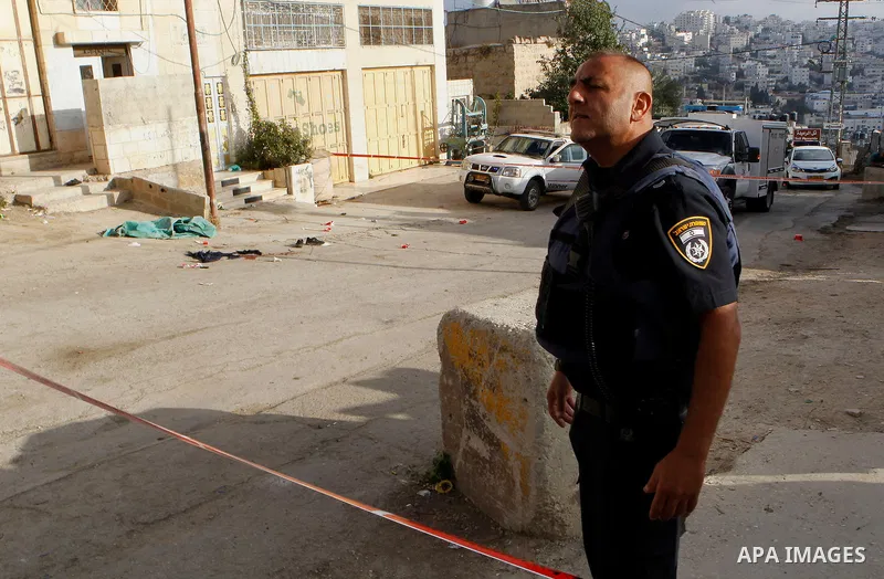 Israeli security forces gather at the scene of a stabbing attack, where a Palestinian stabbed an Israeli soldier before he was shot dead, in the flashpoint West Bank city of Hebron on September 17, 2016. An Israeli milit...