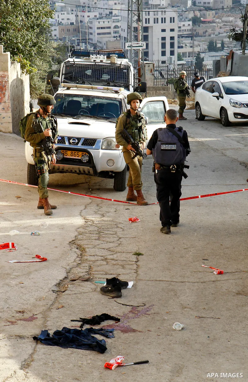 Israeli security forces gather at the scene of a stabbing attack, where a Palestinian stabbed an Israeli soldier before he was shot dead, in the flashpoint West Bank city of Hebron on September 17, 2016. An Israeli milit...