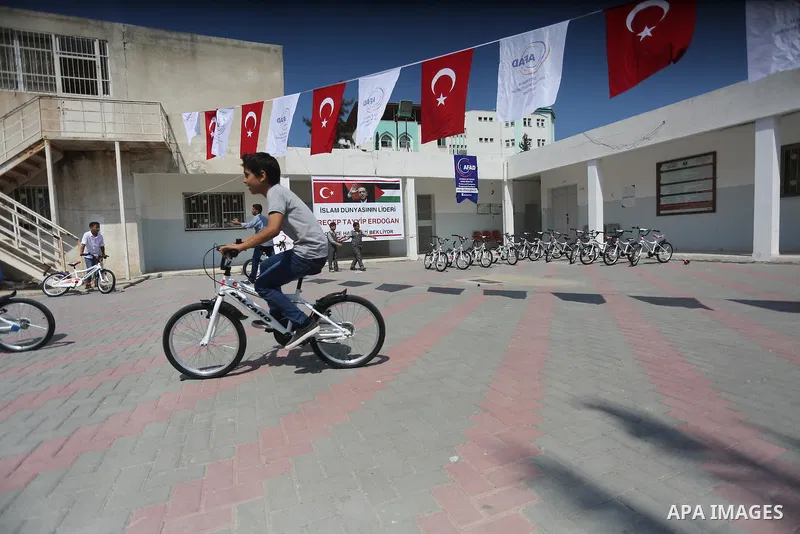 Palestinian orphan student receive bicycles from Turkish aid "clips", in Gaza City, on Sept. 17, 2016. Photo by Mohammed Asad