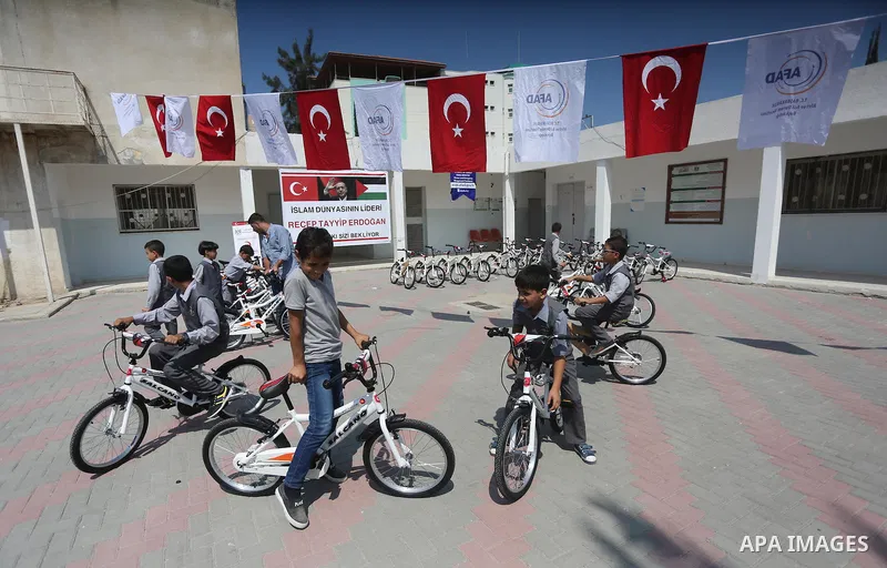 Palestinian orphan student receive bicycles from Turkish aid "clips", in Gaza City, on Sept. 17, 2016. Photo by Mohammed Asad