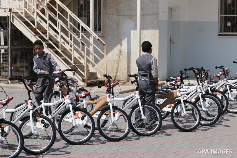 Palestinian orphan student receive bicycles from Turkish aid "clips", in Gaza City, on Sept. 17, 2016. Photo by Mohammed Asad