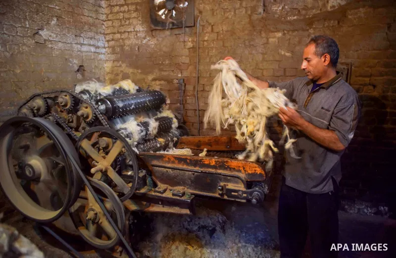 A worker prepares wool for production in a factory in Beheira Governorate, Egypt on September 3, 2016. Photo by Amr Sayed