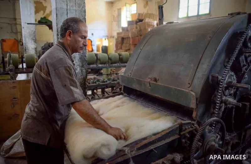 A worker prepares wool for production in a factory in Beheira Governorate, Egypt on September 3, 2016. Photo by Amr Sayed