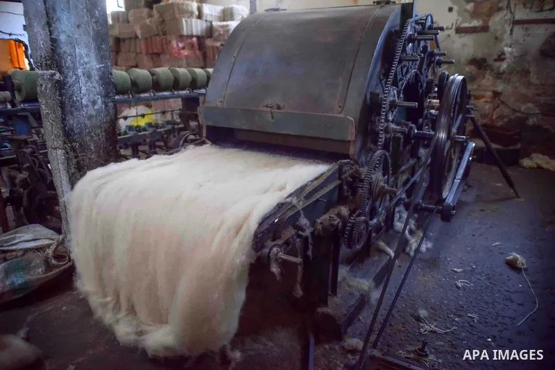 A worker prepares wool for production in a factory in Beheira Governorate, Egypt on September 3, 2016. Photo by Amr Sayed