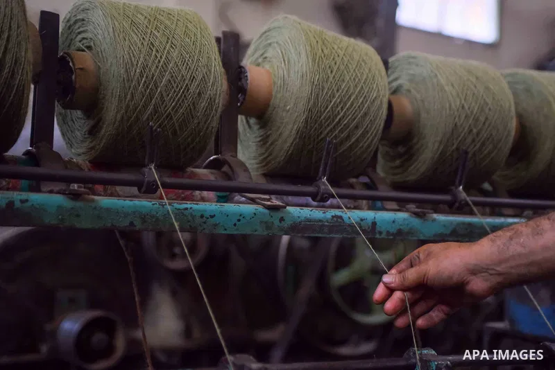 A worker prepares wool for production in a factory in Beheira Governorate, Egypt on September 3, 2016. Photo by Amr Sayed
