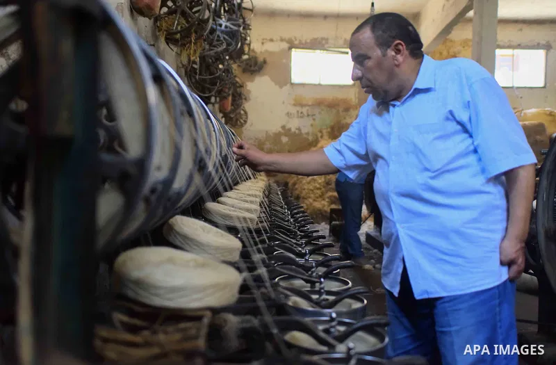 A worker prepares wool for production in a factory in Beheira Governorate, Egypt on September 3, 2016. Photo by Amr Sayed