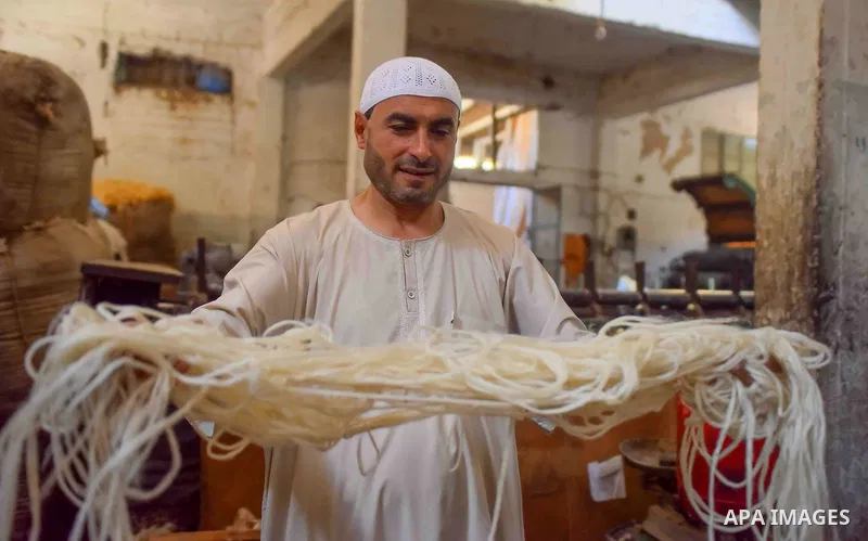 A worker prepares wool for production in a factory in Beheira Governorate, Egypt on September 3, 2016. Photo by Amr Sayed