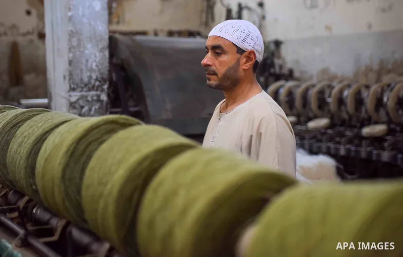 A worker prepares wool for production in a factory in Beheira Governorate, Egypt on September 3, 2016. Photo by Amr Sayed