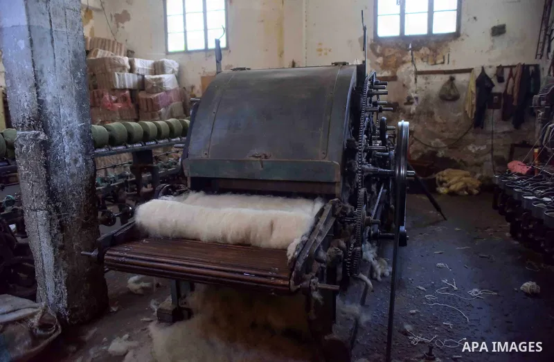 A worker prepares wool for production in a factory in Beheira Governorate, Egypt on September 3, 2016. Photo by Amr Sayed