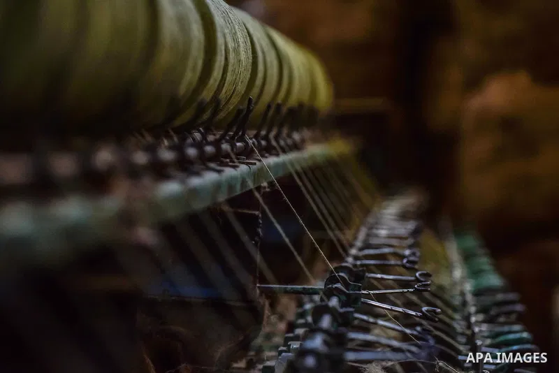 A worker prepares wool for production in a factory in Beheira Governorate, Egypt on September 3, 2016. Photo by Amr Sayed