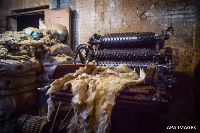 A worker prepares wool for production in a factory in Beheira Governorate, Egypt on September 3, 2016. Photo by Amr Sayed