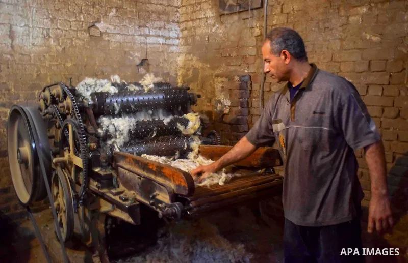 A worker prepares wool for production in a factory in Beheira Governorate, Egypt on September 3, 2016. Photo by Amr Sayed