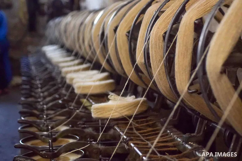 A worker prepares wool for production in a factory in Beheira Governorate, Egypt on September 3, 2016. Photo by Amr Sayed