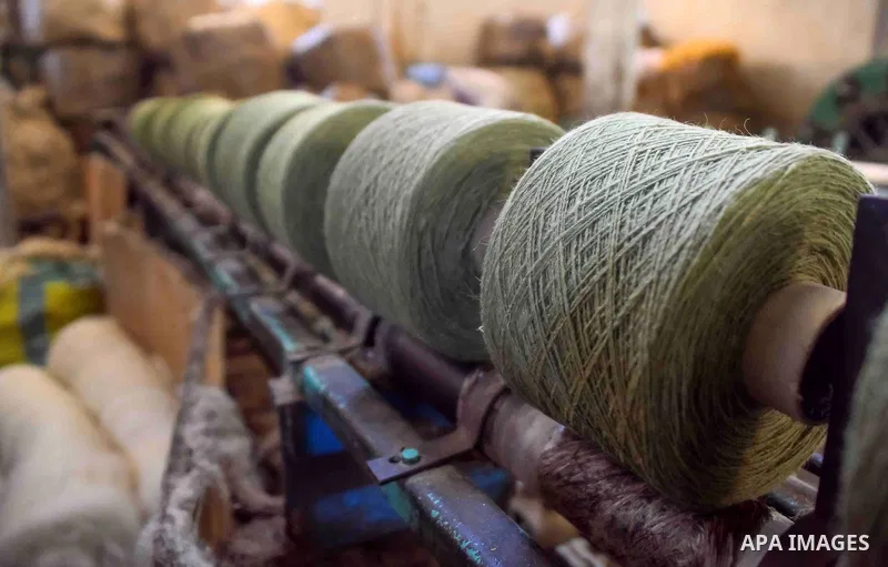 A worker prepares wool for production in a factory in Beheira Governorate, Egypt on September 3, 2016. Photo by Amr Sayed