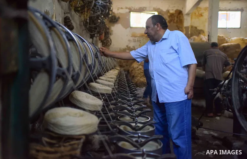 A worker prepares wool for production in a factory in Beheira Governorate, Egypt on September 3, 2016. Photo by Amr Sayed
