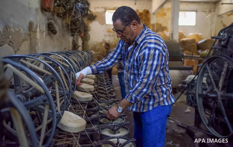 A worker prepares wool for production in a factory in Beheira Governorate, Egypt on September 3, 2016. Photo by Amr Sayed